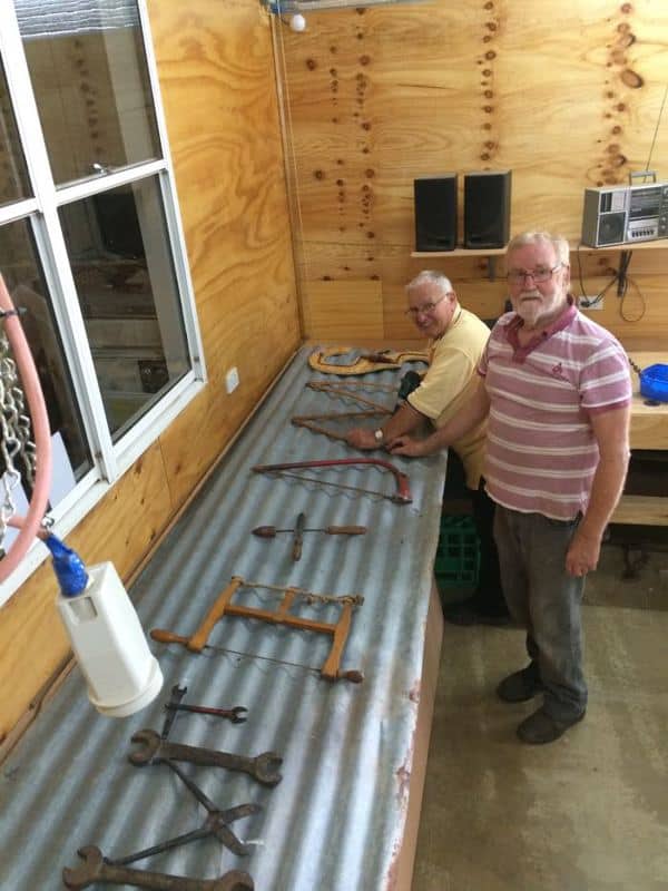 Mal Darwent (front) & Ken Halse designing the Acronym sign made from old tools
